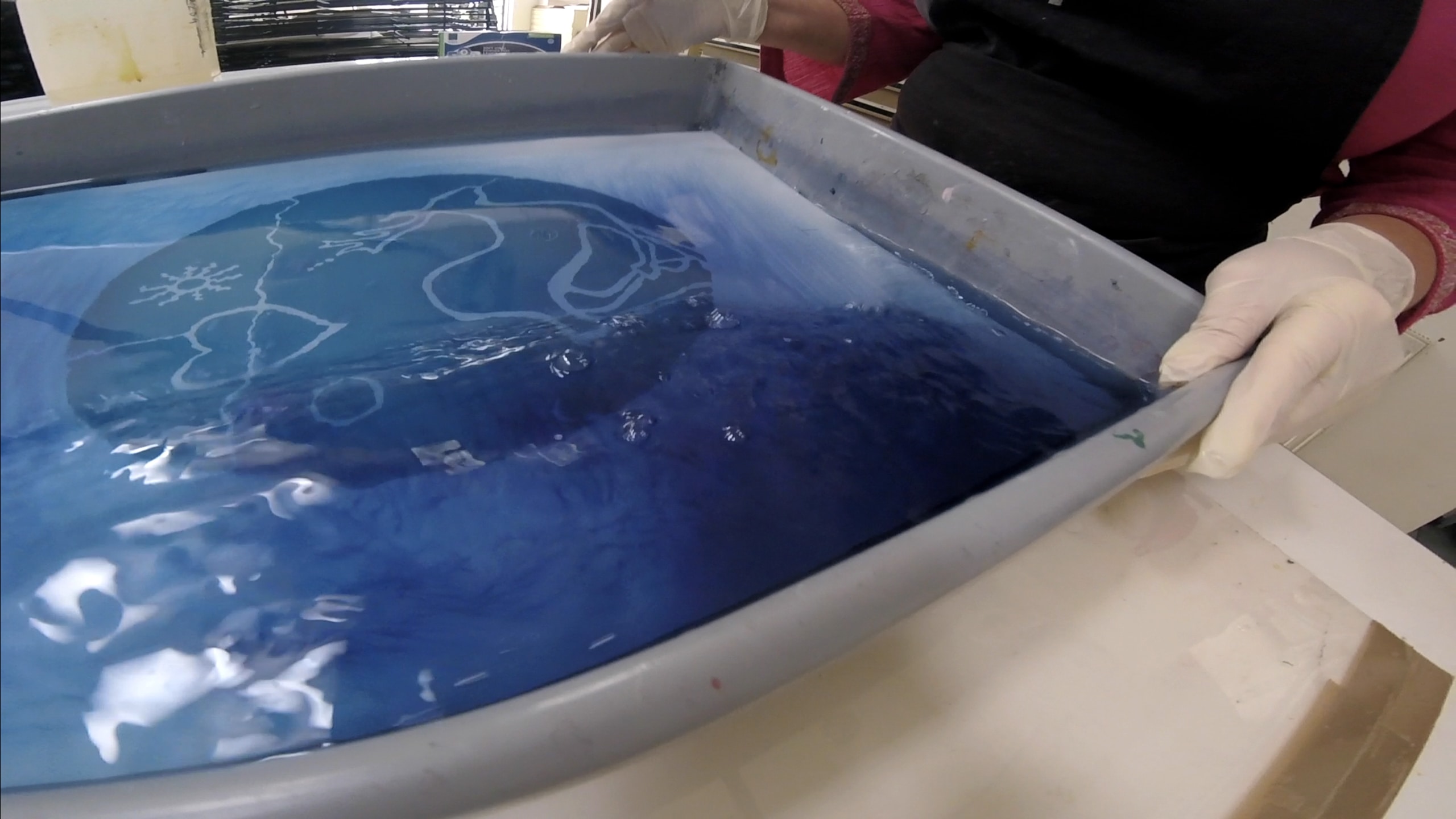 A photo lithography plate being washed in preparation for being printed