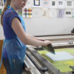 A child learning how to make prints