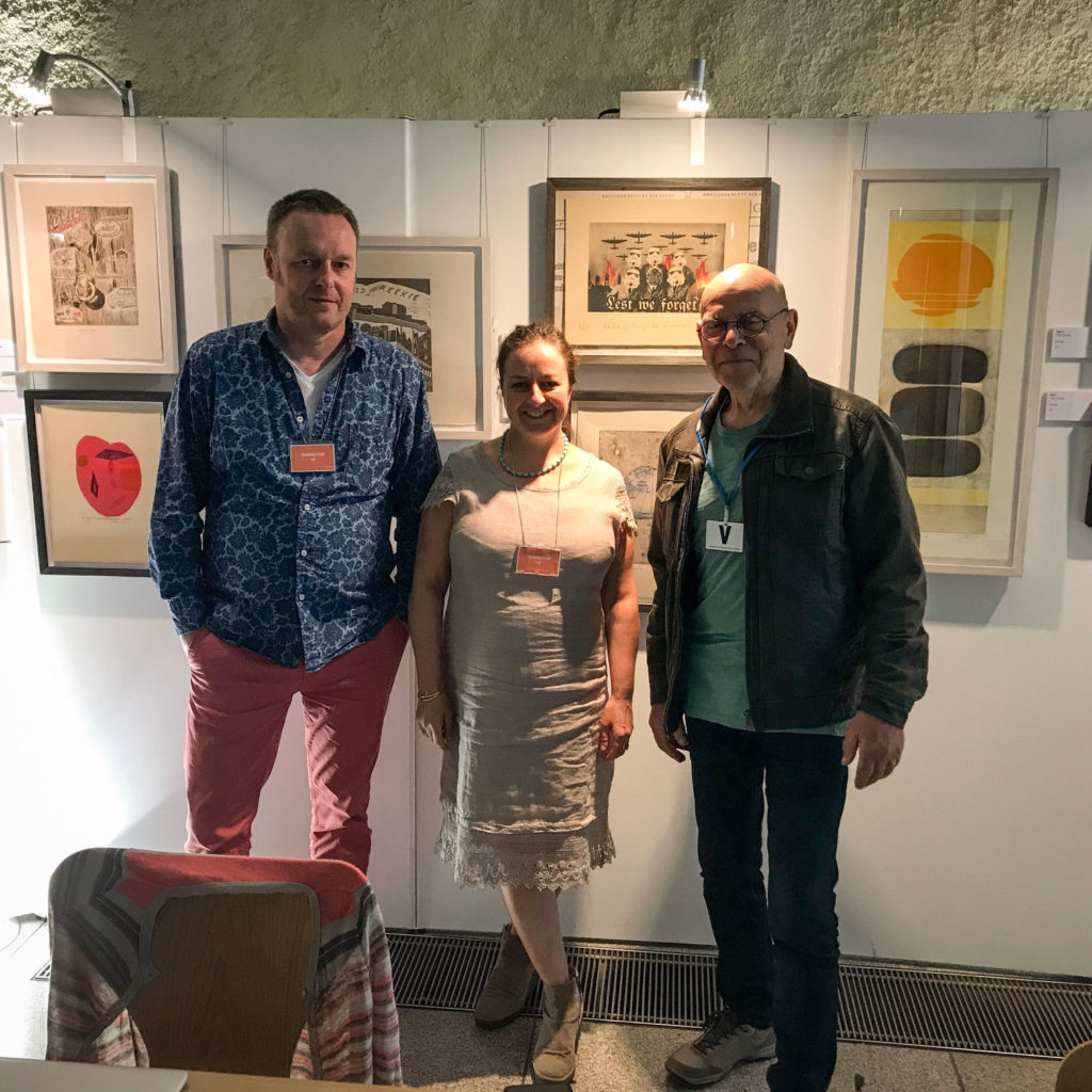 3 people standing in-front of artwork